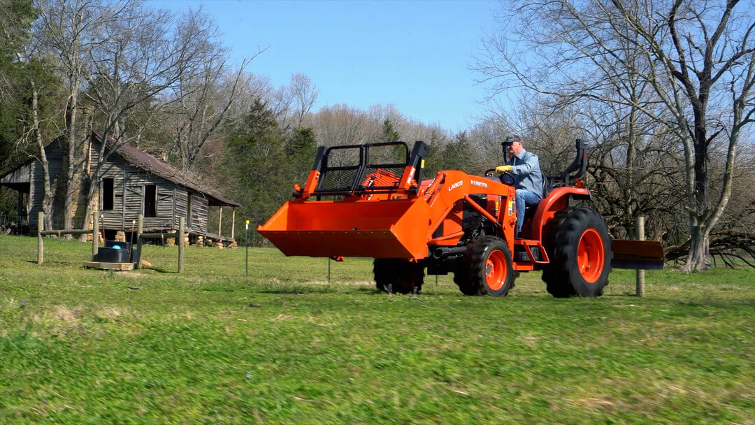Driving a tractor with a Bucket Pro by Battle Armor Designs