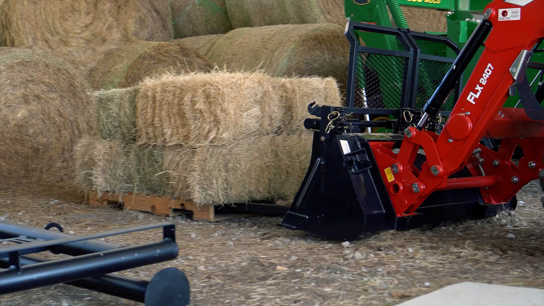 Bucket Pro picking up hay with its forks