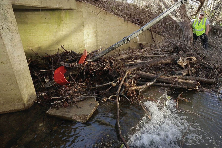 Culvert Cleaner clearing out blockage under a bridge