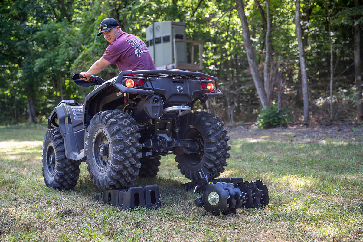 Big Buck Food Plot Plow being installed on an ATV