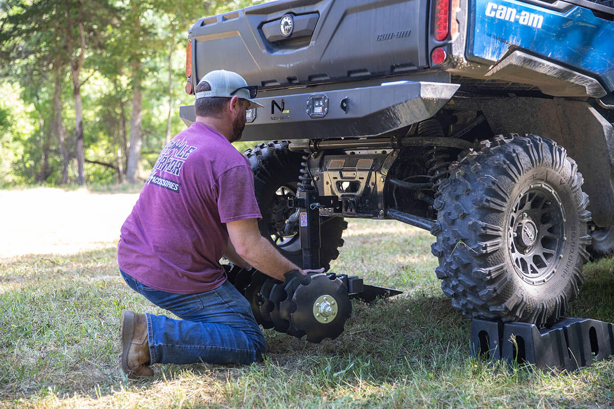 Big Buck Food Plot Plow being installed on an UTV